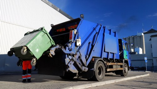 Commercial waste bins ready for collection in Acton