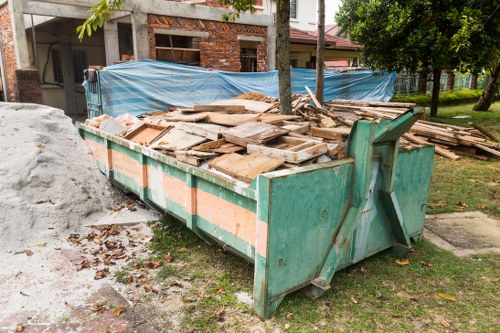 Garden waste being cleared from a residential outdoor space in Acton