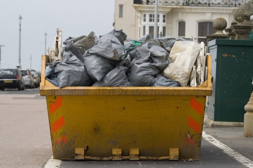 Garden waste and debris being cleared from an Acton property