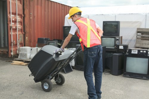 Workers assessing waste and applying safe handling procedures